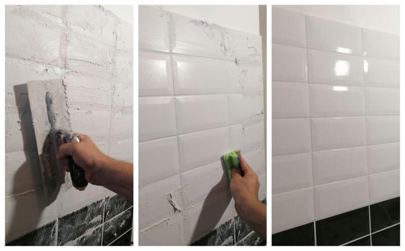 Laying tile on the bathroom wall. Nice and white!